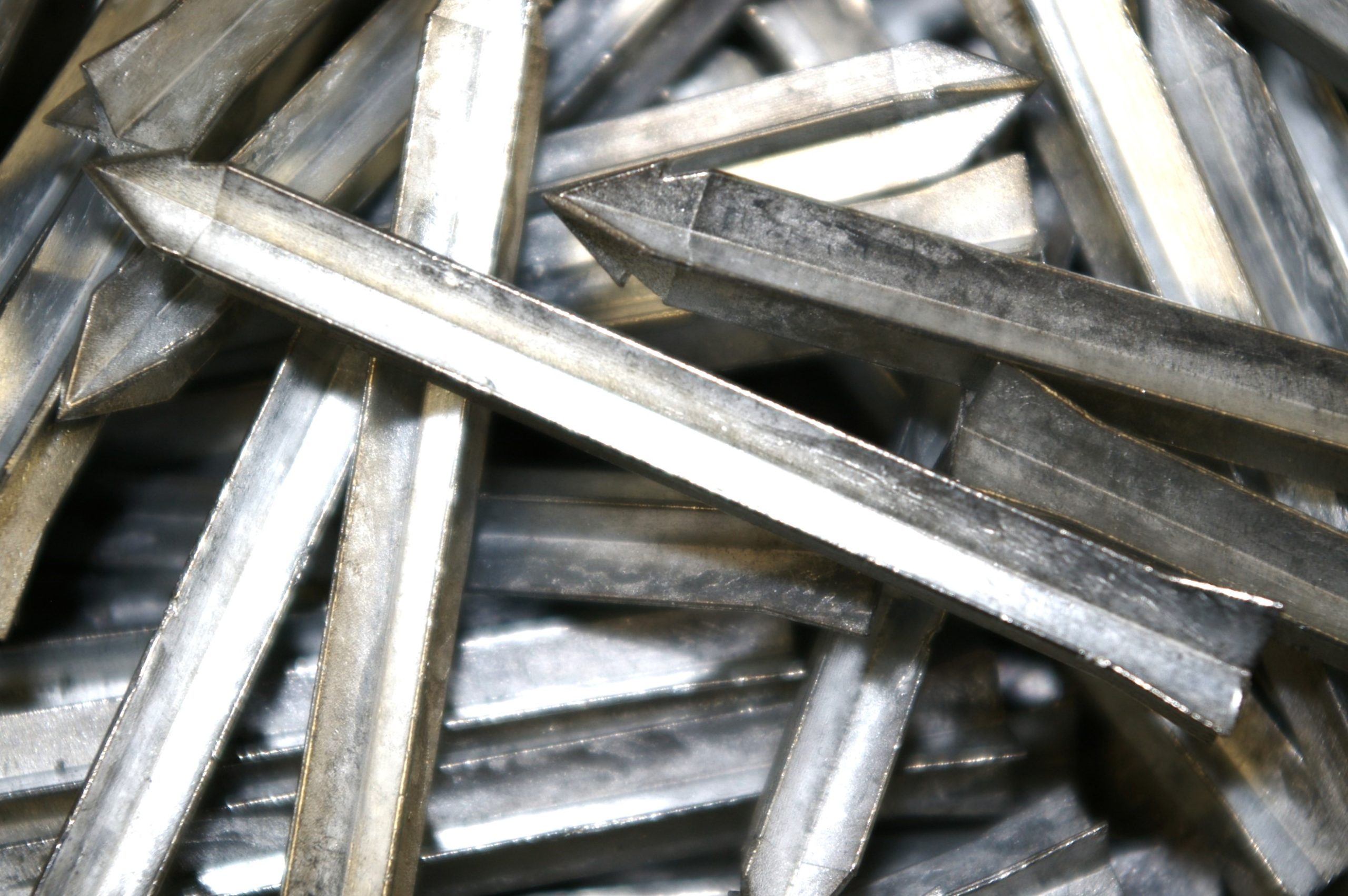 A pile of metal nails in a pile.
